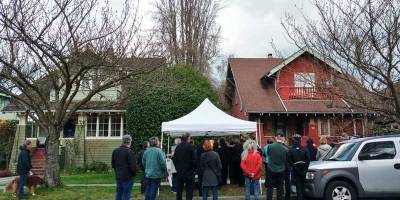 Neighbours at a wake for 4255 W 12th (right), slated for demolition, with media in attendance. The green house next door was built by the same original owner. Photo: Naomi Reichstein