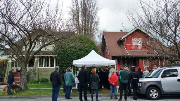 Neighbours at a wake for 4255 W 12th (right), slated for demolition, with media in attendance. The green house next door was built by the same original owner. Photo: Naomi Reichstein